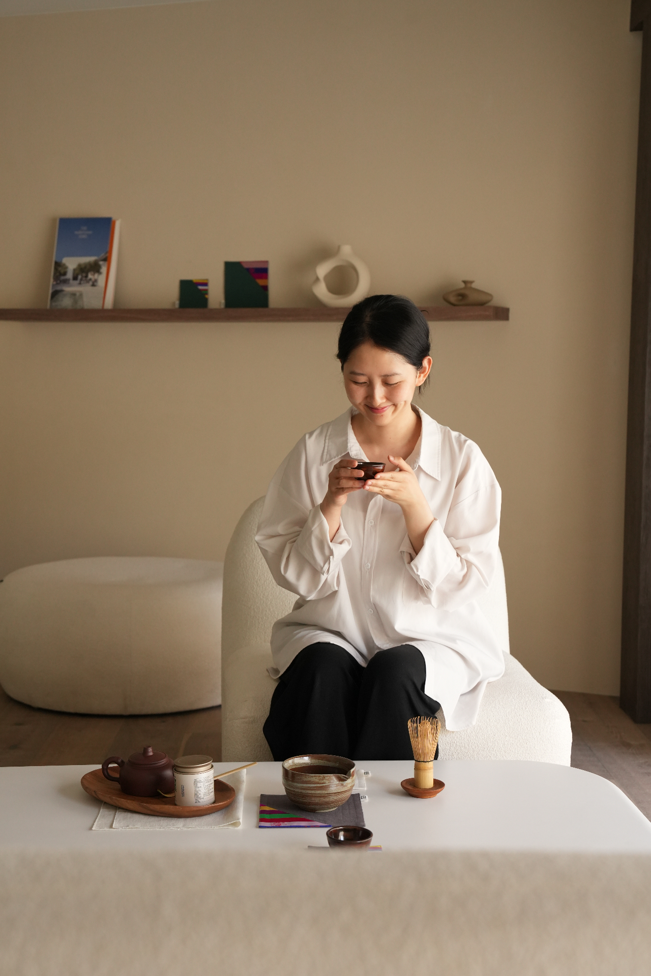 Casa de Gom founder holding a small tea cup